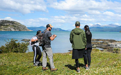 Group of tourists exploring the coastline in Tierra del Fuego National Park.