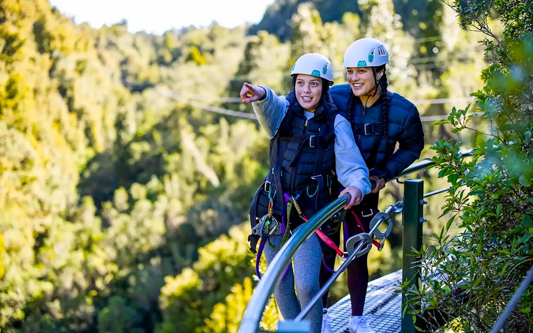 Participants on a Rotorua Forest zipline tour wearing helmets and harnesses.