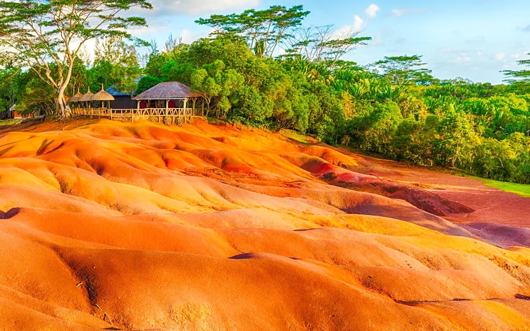 Seven Coloured Earths in Chamarel, Mauritius, with vibrant sand dunes and surrounding greenery.