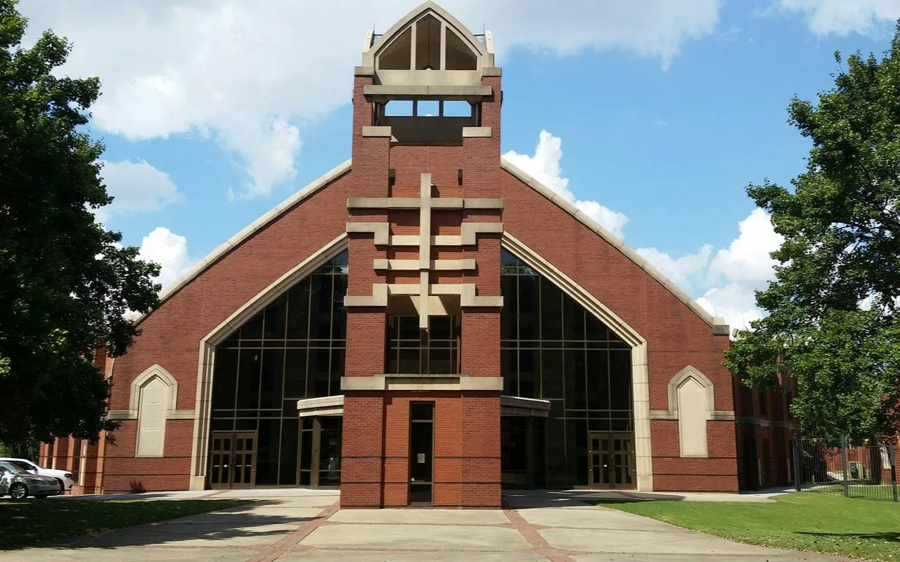 Red brick building with large arched windows in Atlanta, part of the self-guided city exploration game.