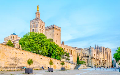 Palais des Papes and Avignon Cathedral with surrounding courtyard in Avignon, France.
