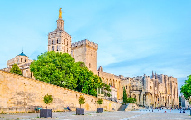 Palais des Papes and Avignon Cathedral with surrounding courtyard in Avignon, France.
