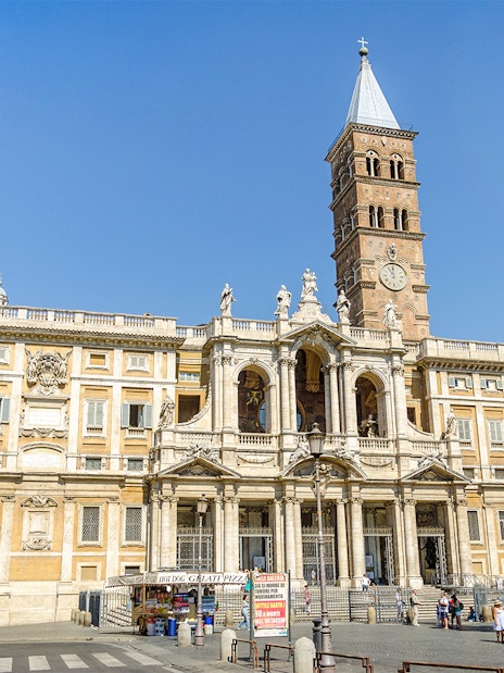 Basilica Santa Maria Maggiore facade with visitors in Rome, Italy.