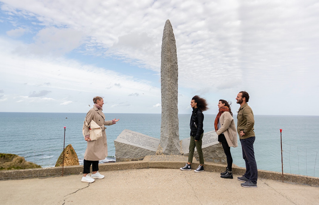 Tourists with guide at Pointe Du Hoc Ranger memorial Omaha Beach, Normandy