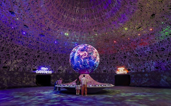 Interactive exhibit with illuminated globe at Biopool in Exploria, Mandai Wildlife.
