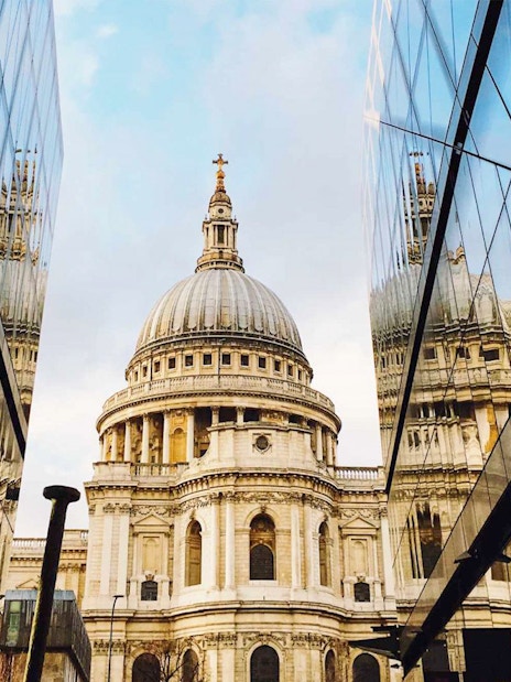 St. Paul's Cathedral reflected in modern glass buildings, London sightseeing on the Afternoon Tea Bus.