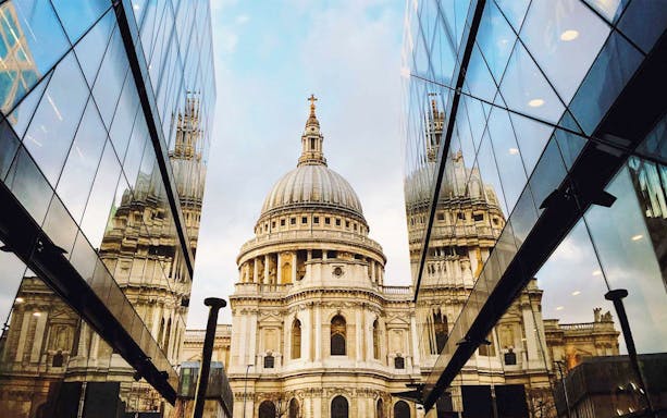 St. Paul's Cathedral reflected in modern glass buildings, London sightseeing on the Afternoon Tea Bus.