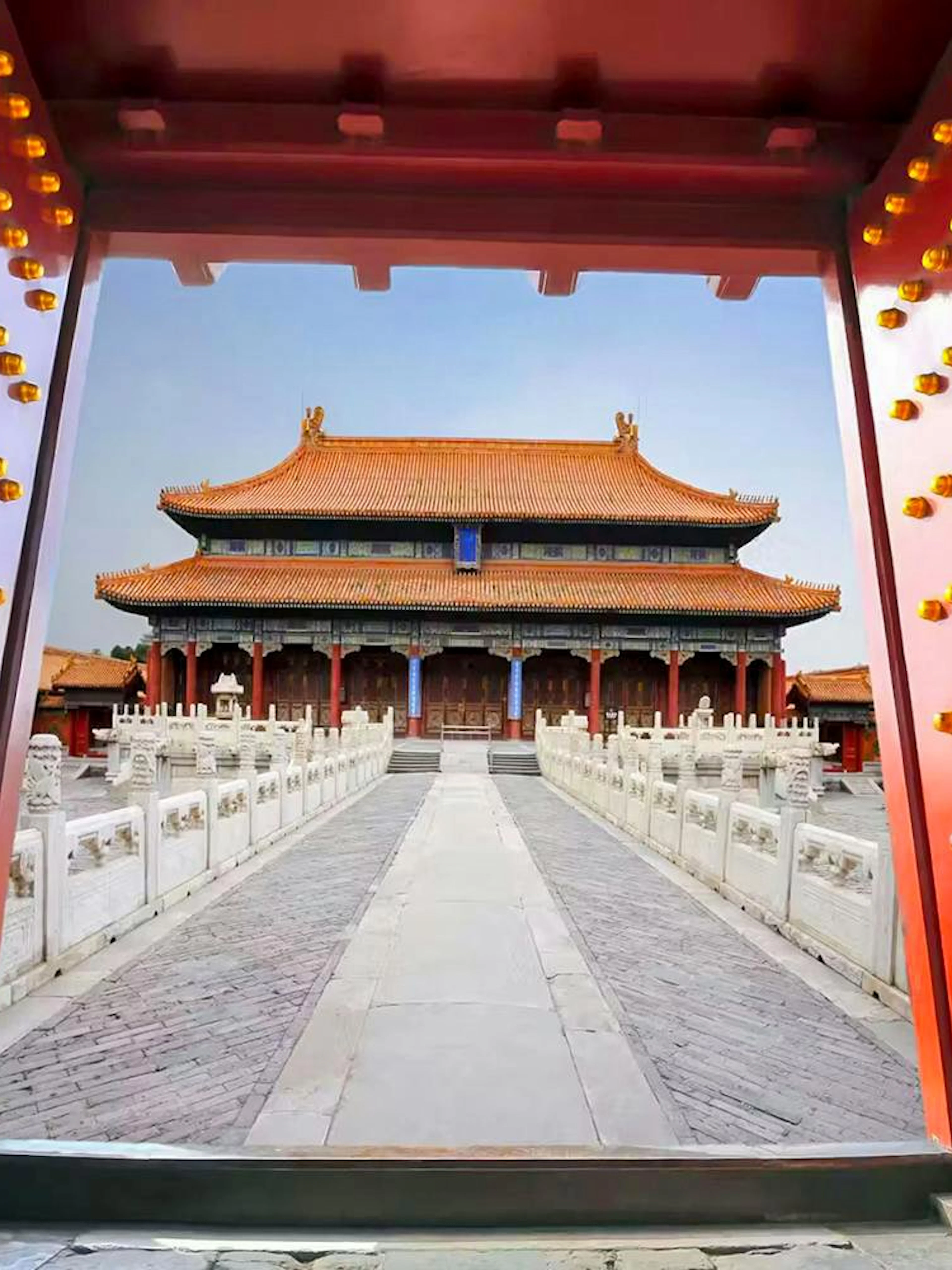 Grand red gates framing the Palace Museum entrance in the Forbidden City, Beijing, China.