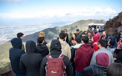 Tour group listening to a guide at Vesuvius National Park near Naples, Italy.