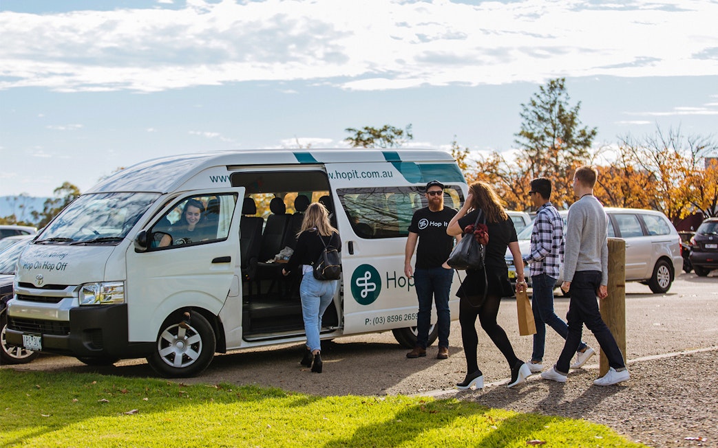 Yarra Valley hop-on-hop-off bus with passengers boarding in Melbourne.