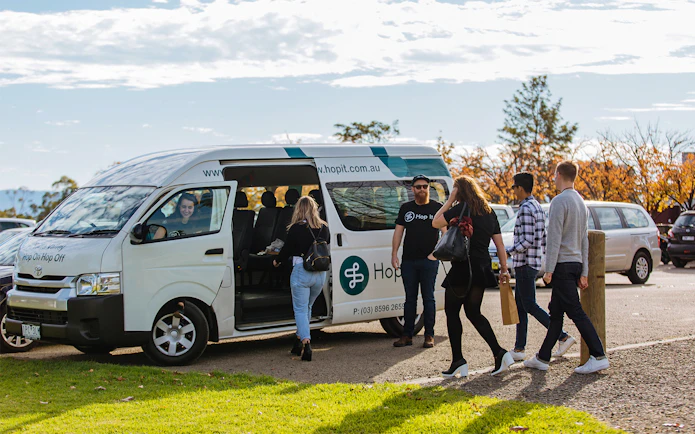 Yarra Valley hop-on-hop-off bus with passengers boarding in Melbourne.