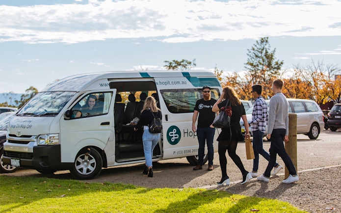 Yarra Valley hop-on-hop-off bus with passengers boarding in Melbourne.