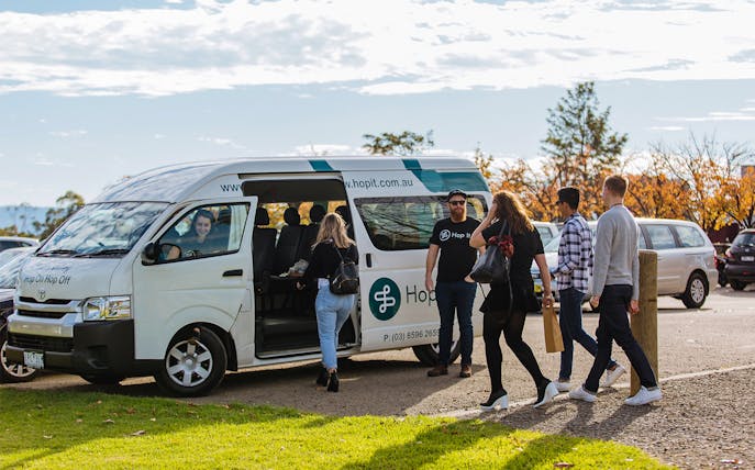 Yarra Valley hop-on-hop-off bus with passengers boarding in Melbourne.