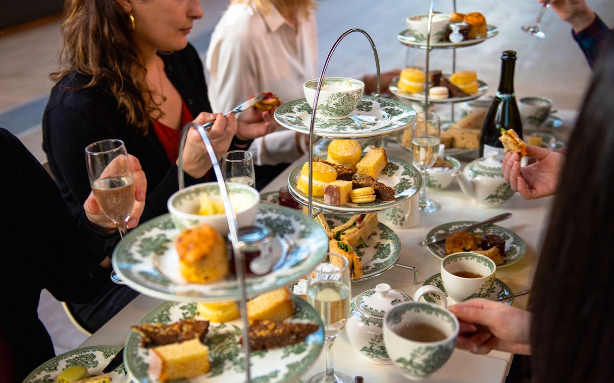 Afternoon tea with pastries and sandwiches at Cutty Sark, London.