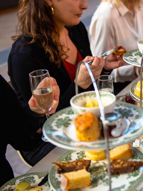 Afternoon tea with pastries and sandwiches at Cutty Sark, London.