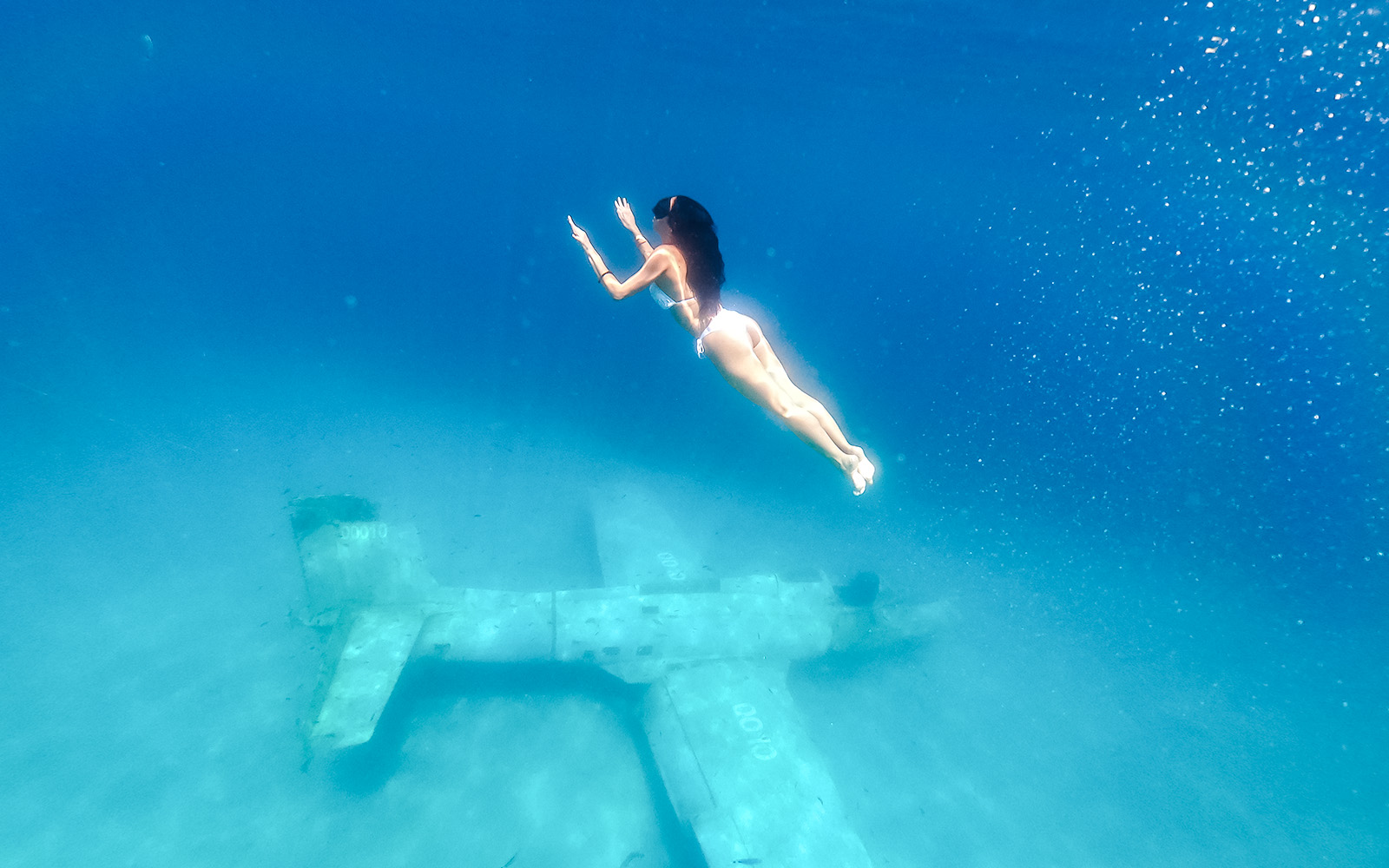 Diver exploring underwater plane wreck at Blue Lagoon, Croatia.