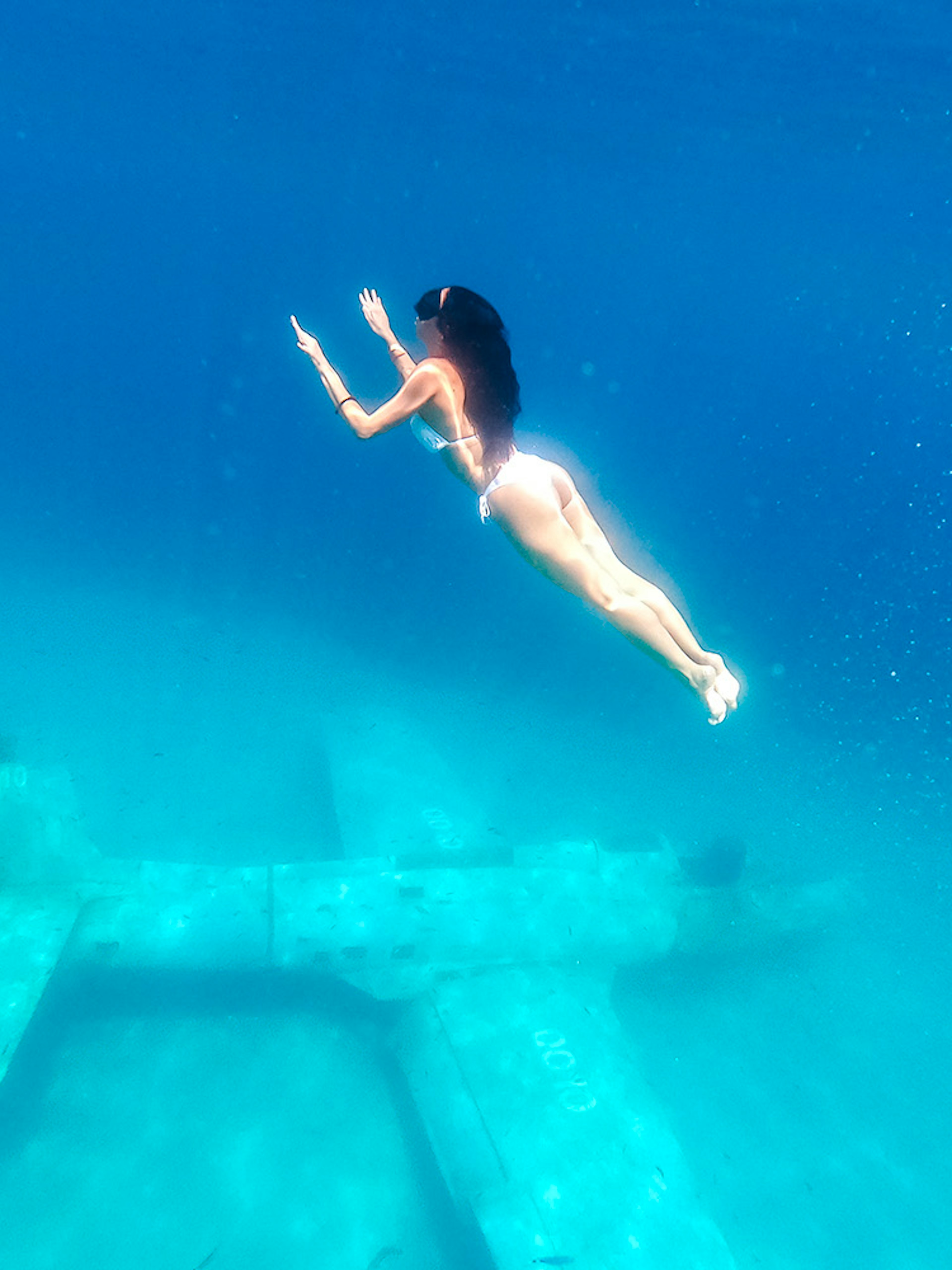 Diver exploring underwater plane wreck at Blue Lagoon, Croatia.