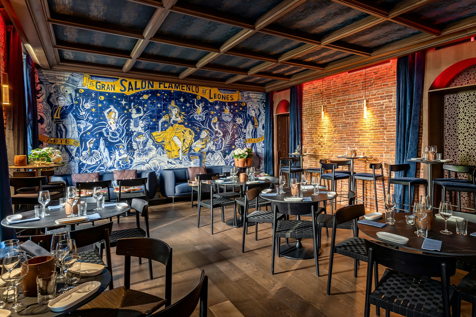 Flamenco De Leones Show venue with mural and dining setup.