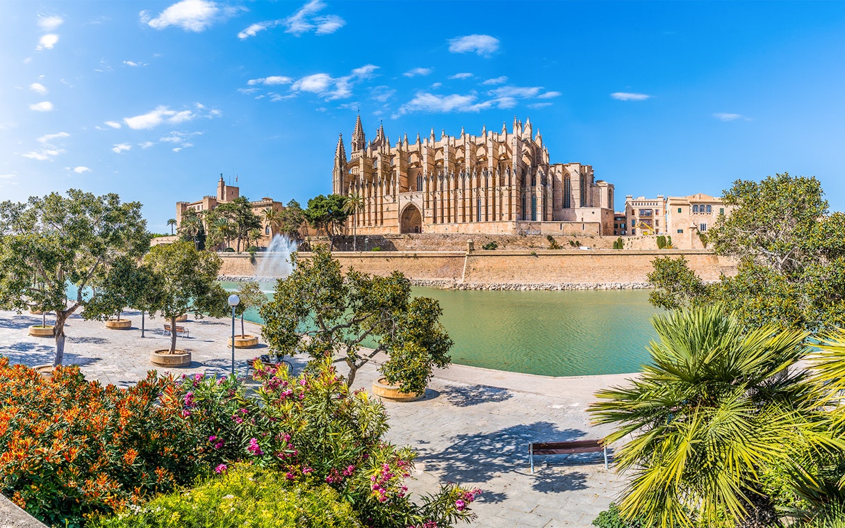 Palma Cathedral with gardens and fountain in foreground, Mallorca, Spain.