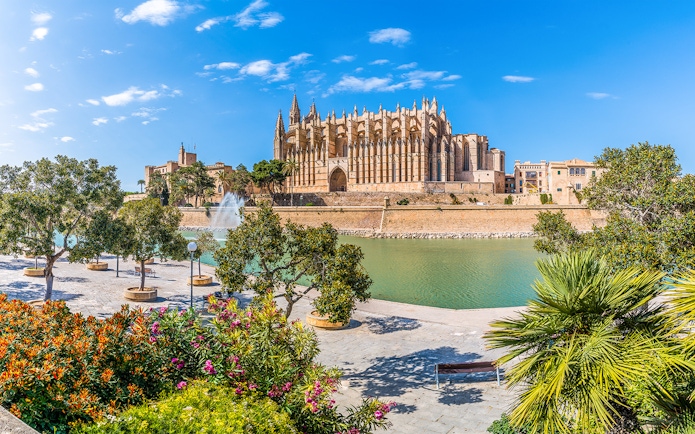 Palma Cathedral with gardens and fountain in foreground, Mallorca, Spain.