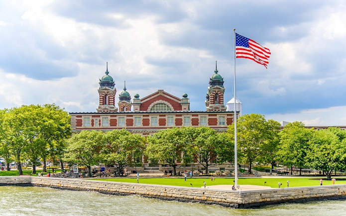 Ellis Island Immigration Museum with American flag, New York City.