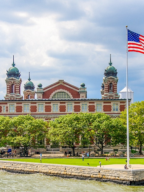 Ellis Island Immigration Museum with American flag, New York City.