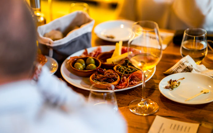 Tapas and drinks on a table during a guided tour in Triana.