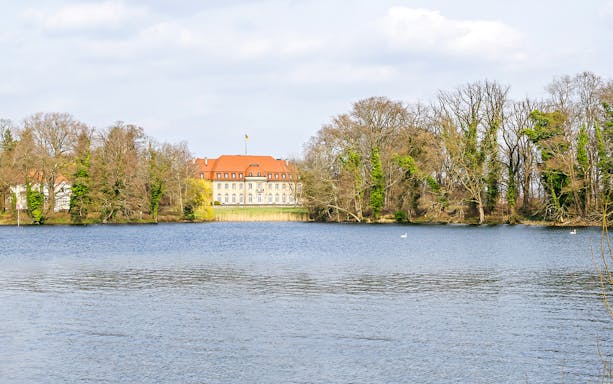 Borsig Villa by Lake Tegel surrounded by trees in Berlin, Germany.