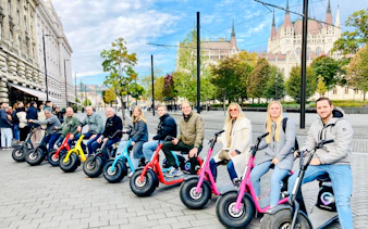 Group on e-scooters in front of Hungarian Parliament, Budapest, during Pest Highlights Tour.