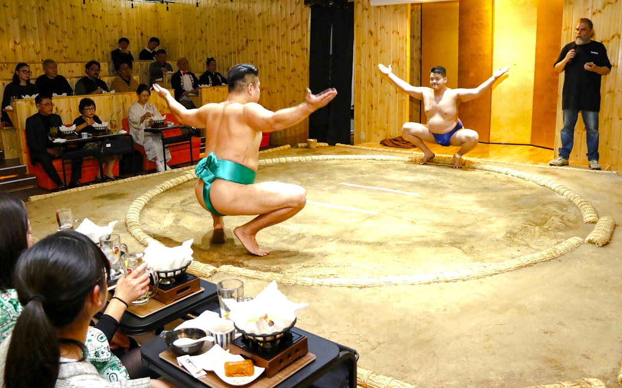 Sumo wrestlers performing in a traditional ring during a Sumo Show Experience in Japan.