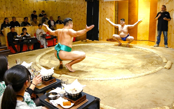 Sumo wrestlers performing in a traditional ring during a Sumo Show Experience in Japan.