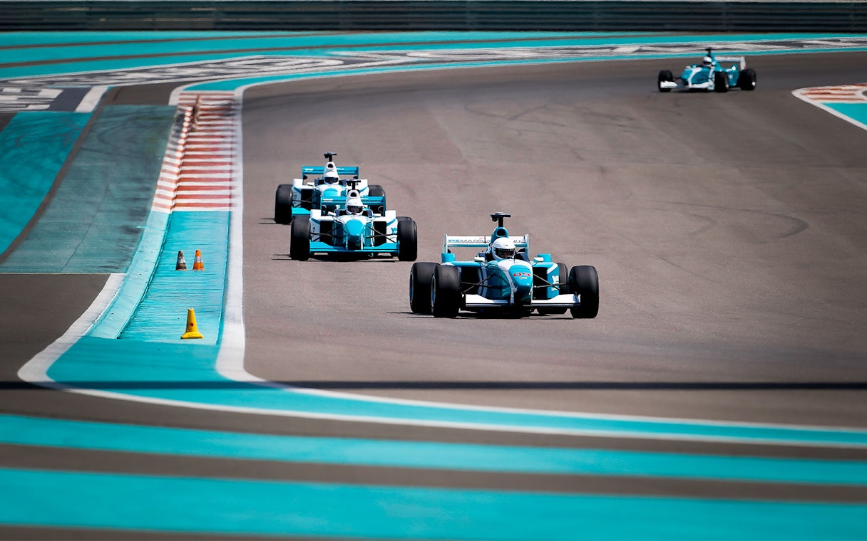 Race cars on track at Yas Marina Circuit during FORMULA YAS 3000 Driving Experience.