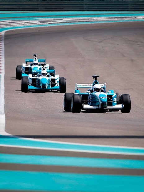 Race cars on track at Yas Marina Circuit during FORMULA YAS 3000 Driving Experience.