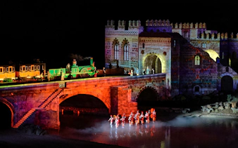 Night show with illuminated train and performers at The Dream of Toledo.