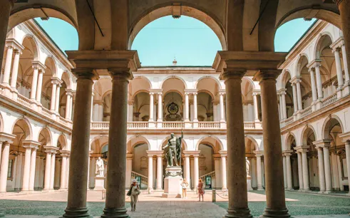 Brera Gallery courtyard with statue and arches, Milan.