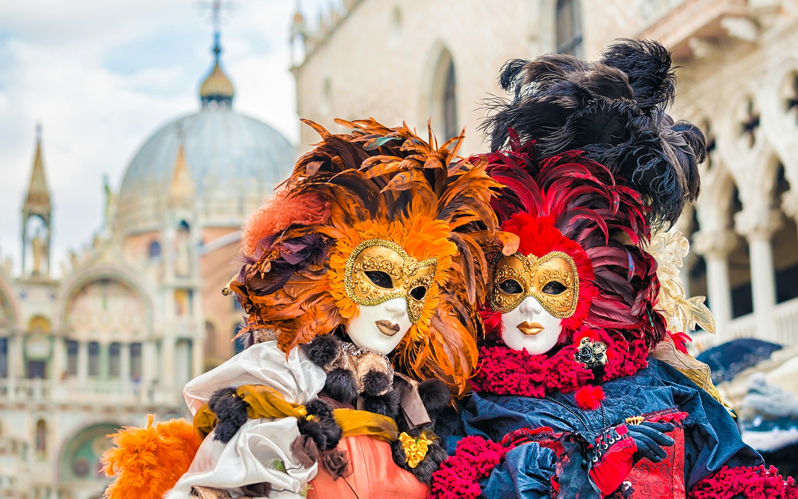 Venice Carnival participants in traditional masks and costumes in Venice, Italy.