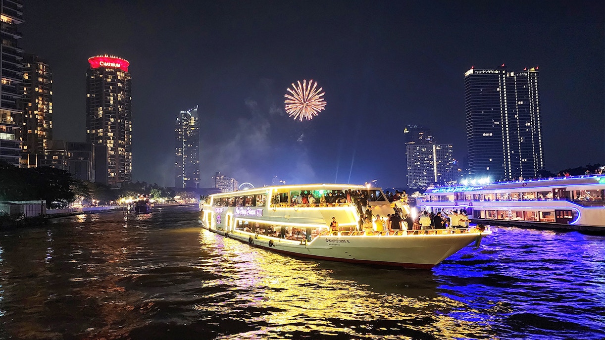 Chao Phraya Princess Cruise with fireworks over Bangkok skyline at night.