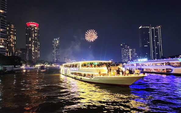 Chao Phraya Princess Cruise with fireworks over Bangkok skyline at night.