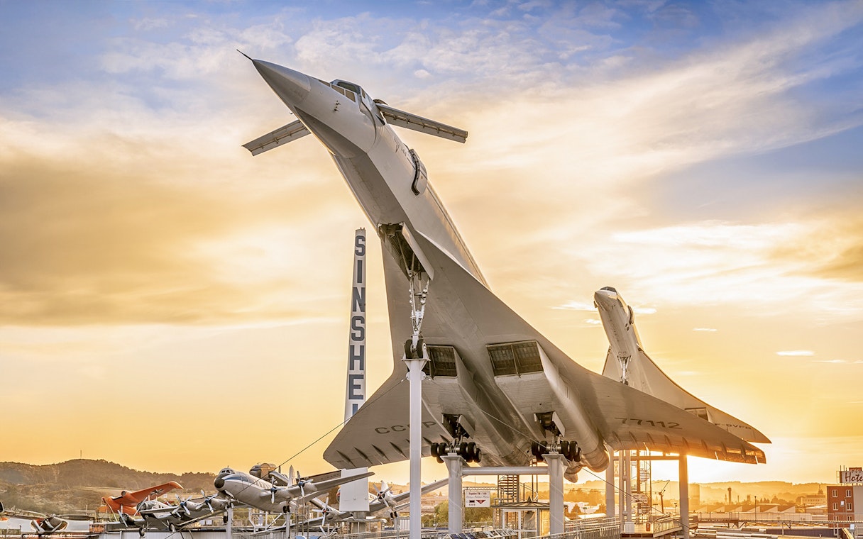 Airplane display at Technik Museum Sinsheim during sunset.