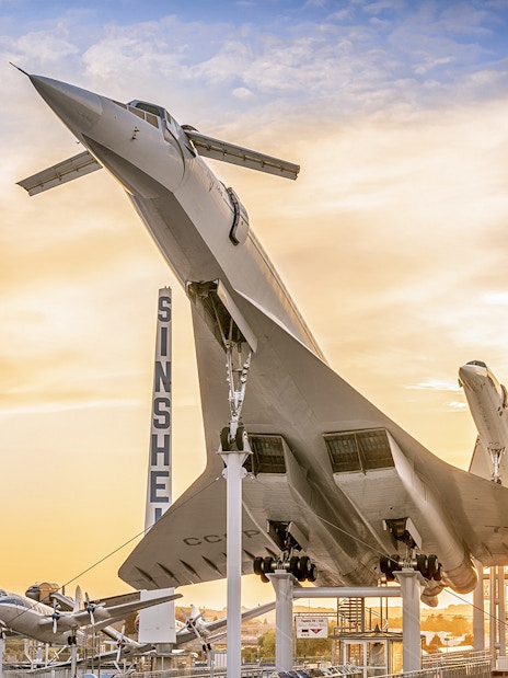 Airplane display at Technik Museum Sinsheim during sunset.