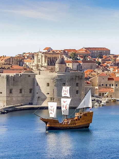 Karaka Ship sailing near Dubrovnik's old town during Elaphiti Islands tour.