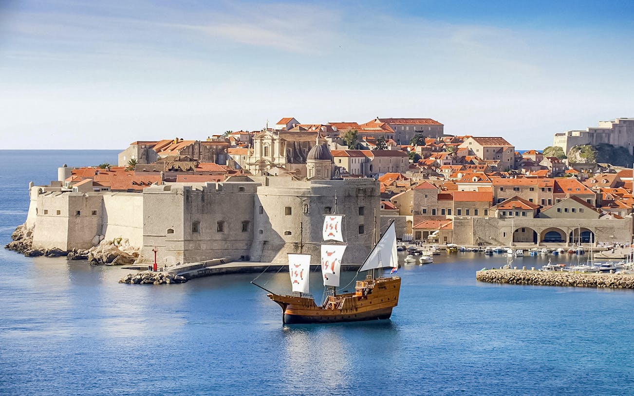 Karaka Ship sailing near Dubrovnik's old town during Elaphiti Islands tour.