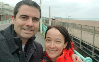 Brighton seafront with couple enjoying self-guided city exploration game.