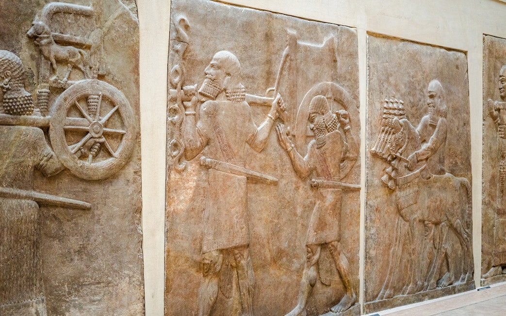 Ancient Assyrian reliefs displayed inside the Louvre Museum, France.