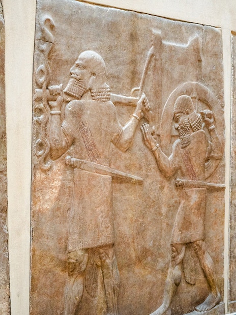 Ancient Assyrian reliefs displayed inside the Louvre Museum, France.