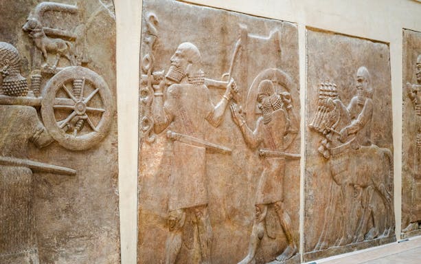 Ancient Assyrian reliefs displayed inside the Louvre Museum, France.