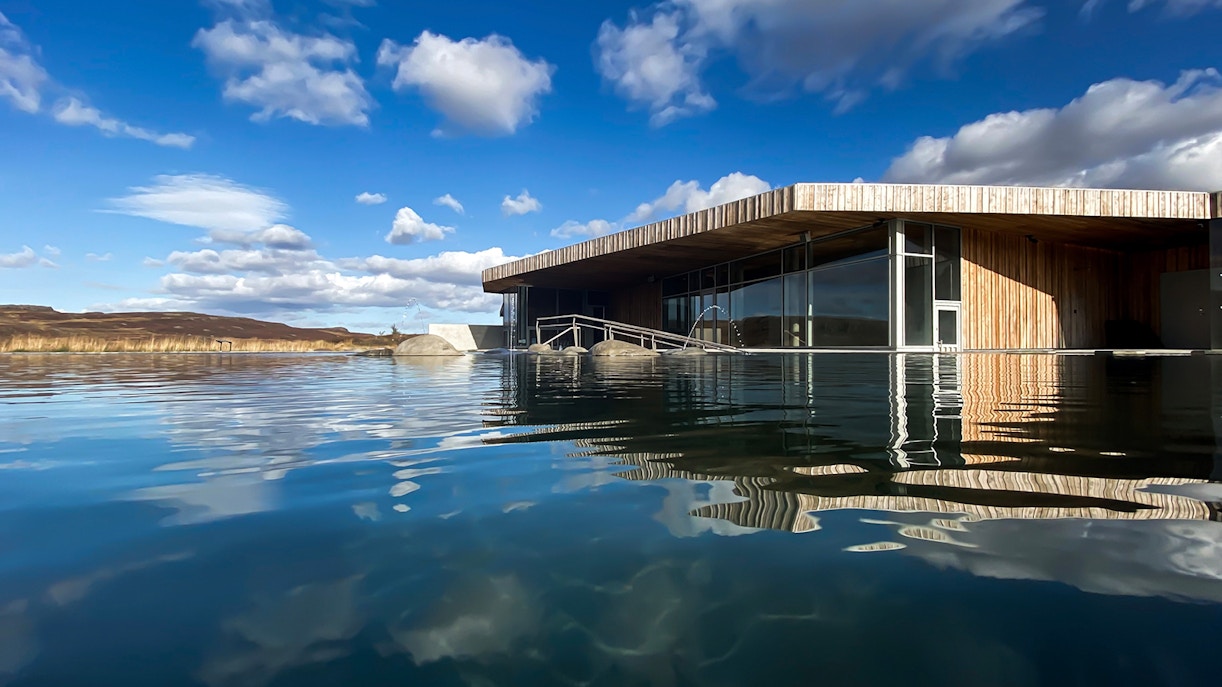 Vök Baths geothermal pool with modern wooden building in Egilsstaðir, Iceland.