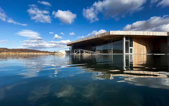 Vök Baths geothermal pool with modern wooden building in Egilsstaðir, Iceland.