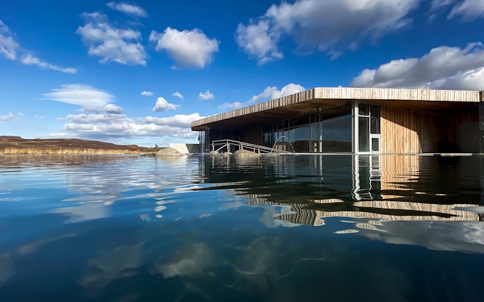 Vök Baths geothermal pool with modern wooden building in Egilsstaðir, Iceland.