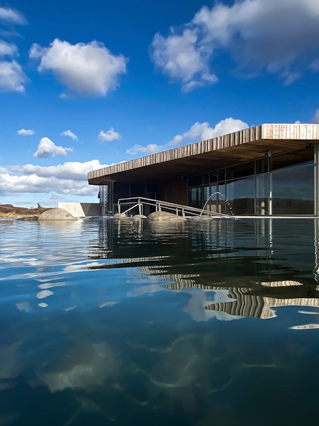 Vök Baths geothermal pool with modern wooden building in Egilsstaðir, Iceland.